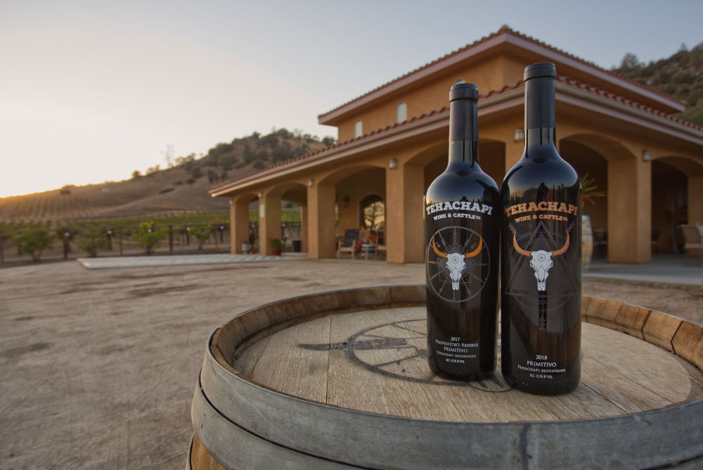 Bottles of primitivo in front of Tehachapi Wine and Cattle Company's tasting room